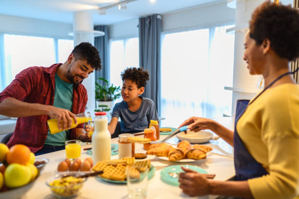 istock Happy black family having breakfast in the kitchen 1370853881