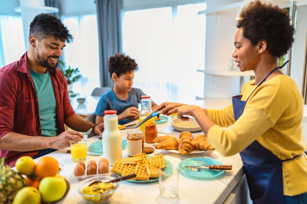 istock Happy black family having breakfast in the kitchen 1370854099