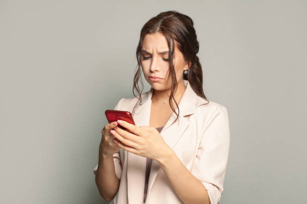 istock Unhappy sad woman messaging, browsing internet and using smartphone 1370854136