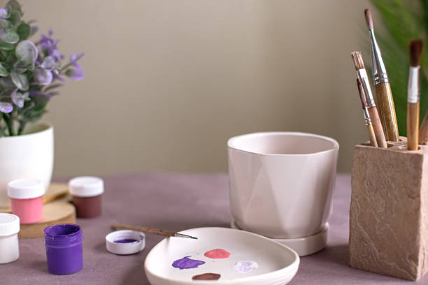 istock A still life with a white ceramic flower pot stands on a table with crafting tools 1370855132