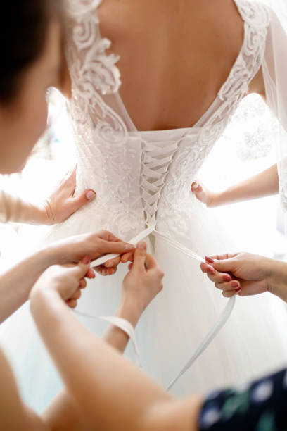 istock lacing a white wedding dress with a white satin ribbon 1370855534