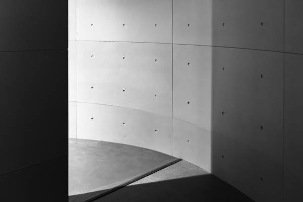 istock Exposed gray concrete wall, cement texture, gray background, cement exterior, corner, doorway, black and white, light colored building 1370856481