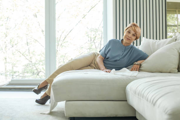 istock Happy mature woman relaxing by the window 1370856734