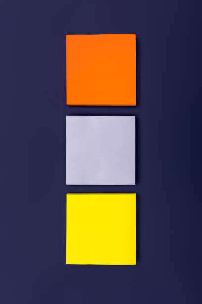 istock Three blank color square sticky note on purple background, top view. Blank space for future important events announcements. Vertical photo 1370856798