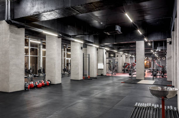 istock Exercise machines for physical training in spacious, well lit, empty gym interior with huge windows. Special contemporary equipment. Sport, fitness 1370857416