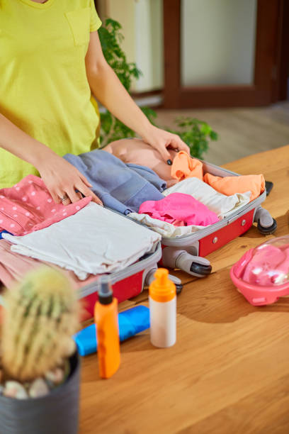 istock Unrecognizable Woman hand packing suitcase, put snorkeling, 1370857572