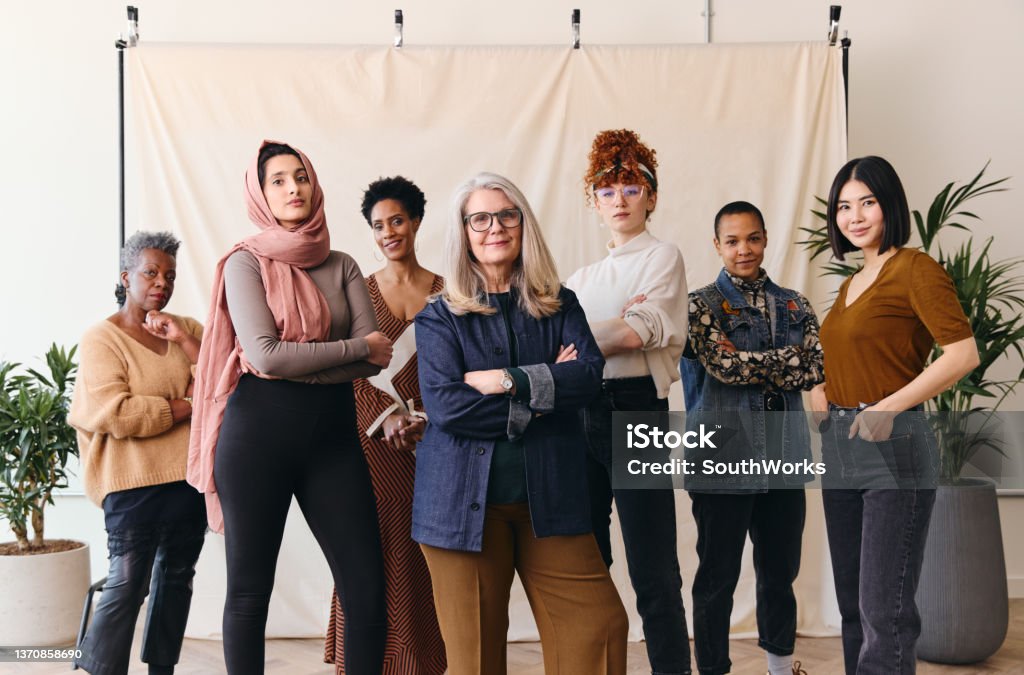 International Women's Day portrait of multi ethnic mixed age range women looking confidently towards camera Women Stock Photo