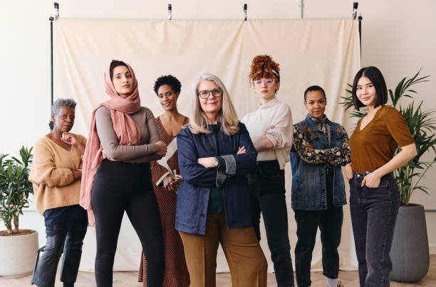 International Women's Day portrait of multi ethnic mixed age range women looking confidently towards camera International Women's Day portrait of multi ethnic mixed age range women looking confidently towards camera womens rights stock pictures, royalty-free photos & images