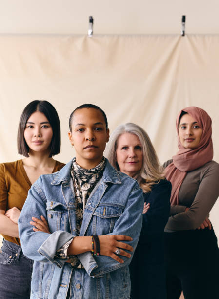 mid adult mixed race lgbtq woman in support of international women's day with multi ethnic female friends - multiracial woman imagens e fotografias de stock