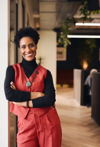 Photo of Portrait of confident mature black woman smiling and looking at camera in office space