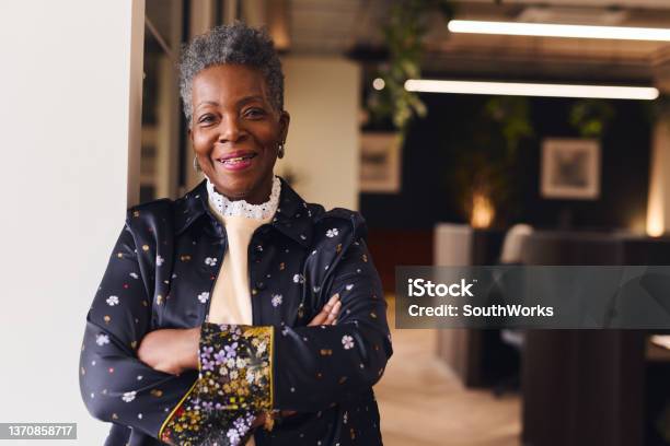 Portrait Of Confident Senior Black Woman Smiling And Looking At Camera With Arms Folded Stock Photo - Download Image Now
