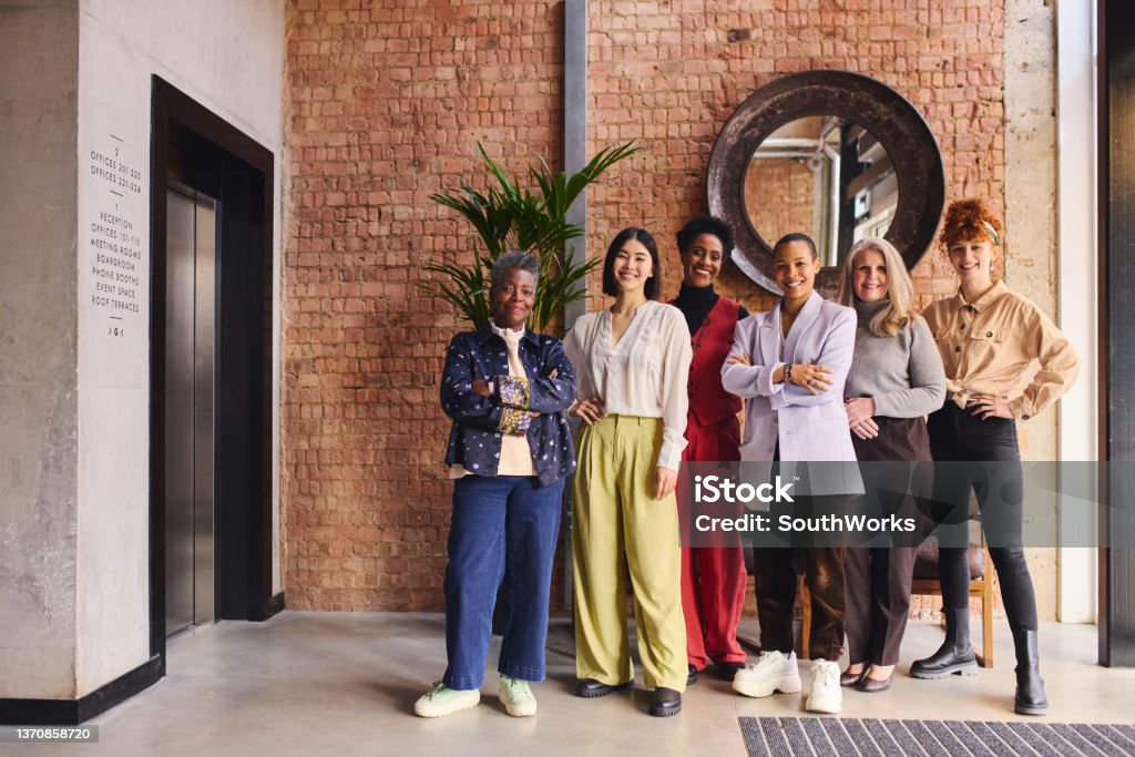 International Women's Day portrait of united multi ethnic mixed age range women in business Women Stock Photo
