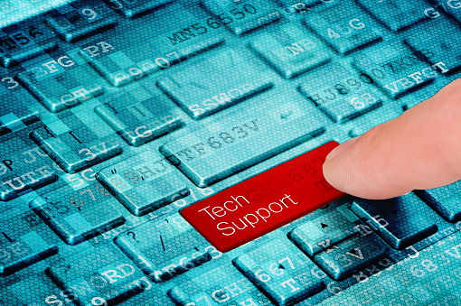 A finger press red Tech Support  button on blue digital laptop keyboard
