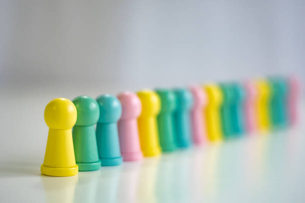 istock Row of colorful pawns in line 1370859086