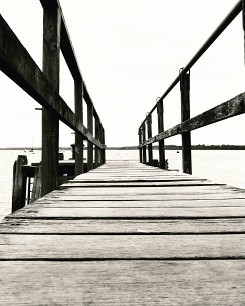 Wooden pier, jetty walkway in black and white