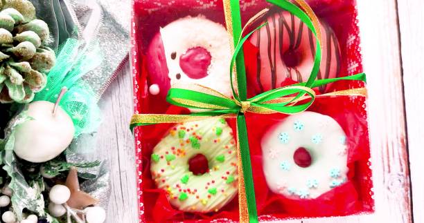 istock unpacking a christmas donut box, donuts with icing and sprinkles 1370860542