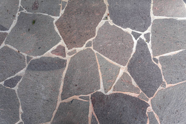 istock Stone pavement with abstract pattern closeup. crumble with age. construction, repair. concept of destruction, decline. High quality photo 1370860969