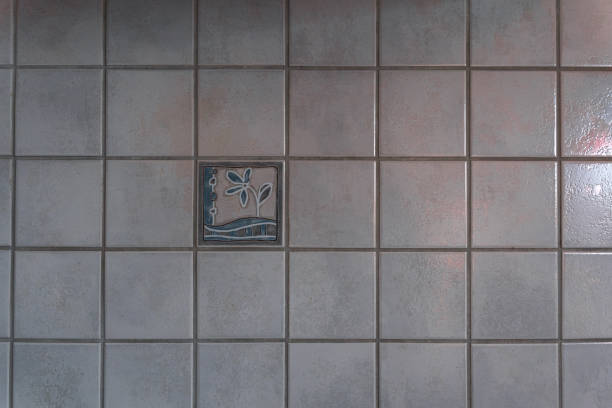 Old tiles with decor on the background. Light tiled wall. High quality photo