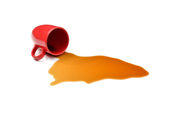 Spilled Coffee Mug knocked over with spilt coffee isolated on white background spilling stock pictures, royalty-free photos & images