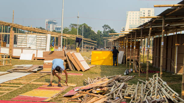 People working hard for the book fair 2022. This image was captured by me on February 9, 2022, from Dhaka, Bangladesh. Preparation of book fair 2022, People working hard for the book fair 2022. This image was captured by me on February 9, 2022, from Dhaka, Bangladesh. elon musk stock pictures, royalty-free photos & images