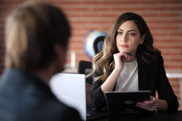 Businesswoman Interviewing Male Job candidate In The Office Meeting Room stock photo
