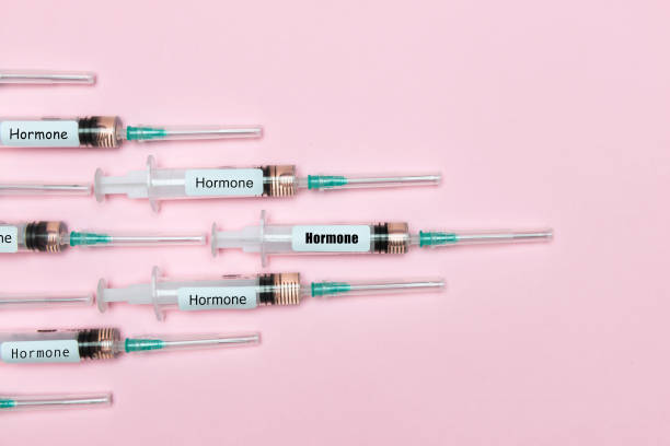 Hormone Injections Vaccination syringes with Hormone written using different fonts building a triangle on the left side of the image like they were fighter jets in a war against illnesses. oestrogen stock pictures, royalty-free photos & images
