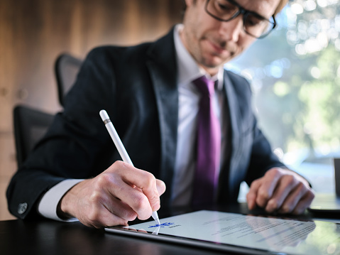 Man Signing The Digital Contract