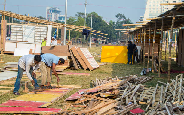 People working hard for the book fair 2022. This image was captured by me on February 9, 2022, from Dhaka, Bangladesh. Preparation of book fair 2022, People working hard for the book fair 2022. This image was captured by me on February 9, 2022, from Dhaka, Bangladesh. elon musk stock pictures, royalty-free photos & images