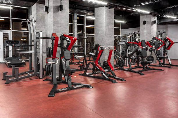 istock Exercise machines in spacious, well lit, empty gym interior. Special modern equipment for physical training. Sport, fitness 1370864533