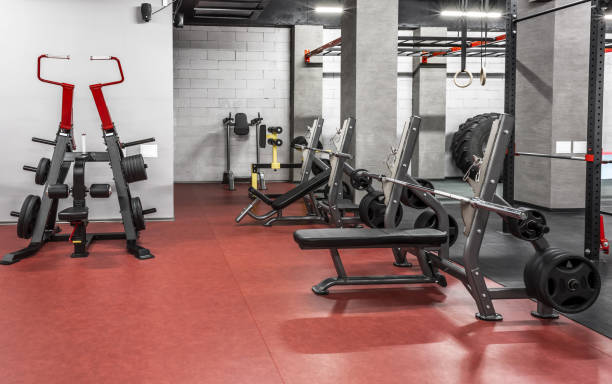 istock Various powerlifting equipment in spacious, well lit, empty gym interior. Special modern exercise machines for physical training. Sport, fitness 1370864581