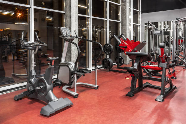 istock Various special equipment for physical training by the window in spacious, well lit, empty gym interior. Modern exercise machines. Sport, fitnes 1370864587