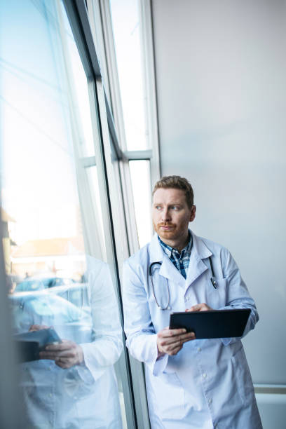 istock Young worried doctor looking at the results 1370866694