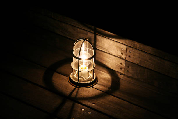 istock Lamp on a wood deck lit at night. 1370867567