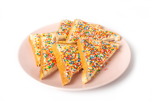 Traditional Australian fairy bread on plate isolated on white background.