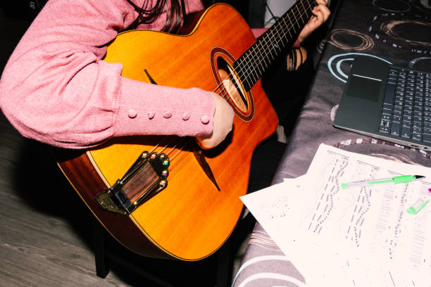 istock Young girl learning to play the guitar 1370871189