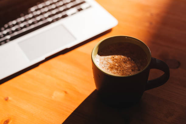 istock Coffee break in the office, laptop computer and coffee cup on the desk 1370871304