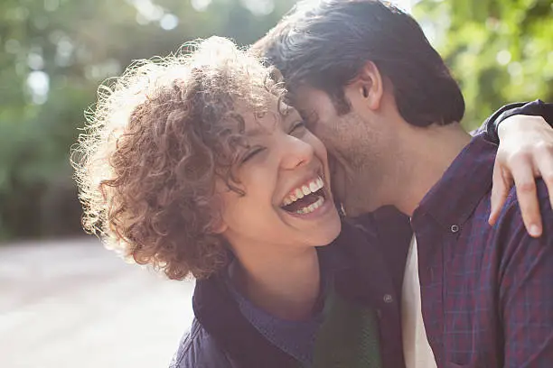 Photo of Close up laughing couple hugging