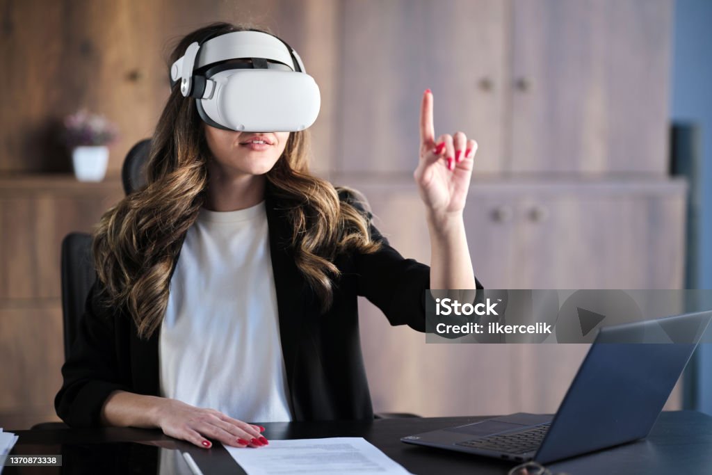 Businesswoman Wearing VR Headset Running A Business Meeting At Home Metaverse Stock Photo