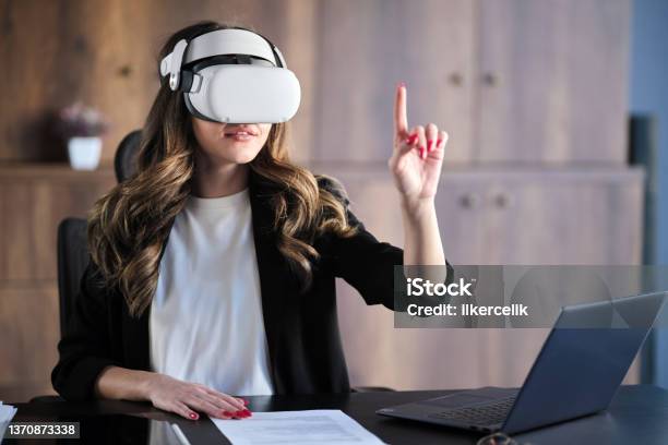 Businesswoman Wearing Vr Headset Running A Business Meeting At Home Stock Photo - Download Image Now