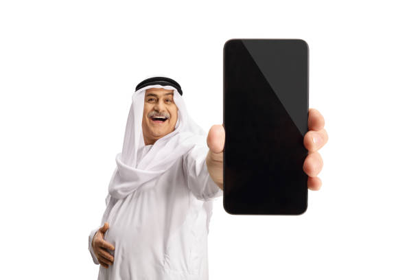 istock Mature arab man holding a smartphone in front of camera 1370874005