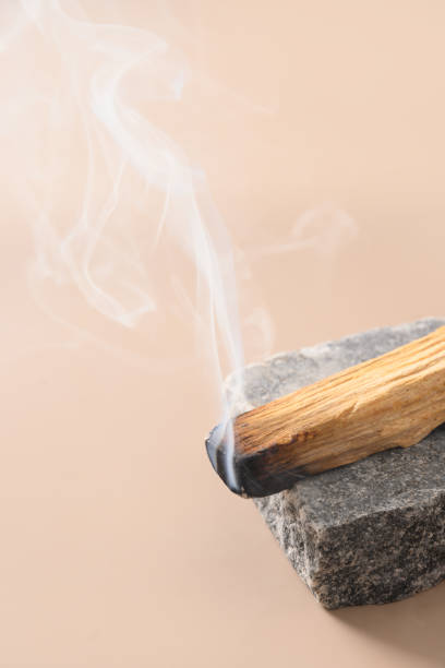istock Palo Santo stick incense burning on stone. 1370874016