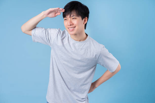 istock Young Asian man posing on blue background 1370874024