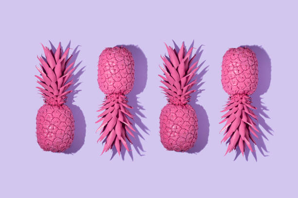 istock Creative pattern with bright pink painted pineapple on pastel purple background. Trendy fruit concept. Minimal food colorful idea. 1370874073