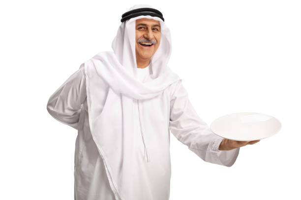 istock Mature arab man holding an empty plate and smiling 1370874675