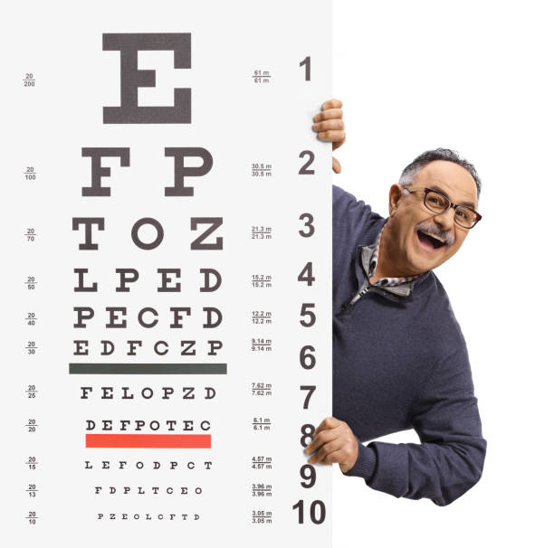 istock Mature man wearing glasses and peeking from behind an eye test 1370875192