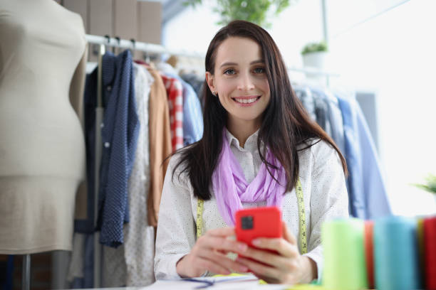 istock A woman seamstress holds a smartphone, close-up 1370876317