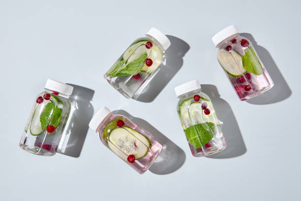 istock Plastic bottle mockup on empty pink background. Set from detox water with cucumber, mint and berries. Design bottle mockup. Beverage for healthy, sport or diet. Detox drink in transparent bottle. 1370877455