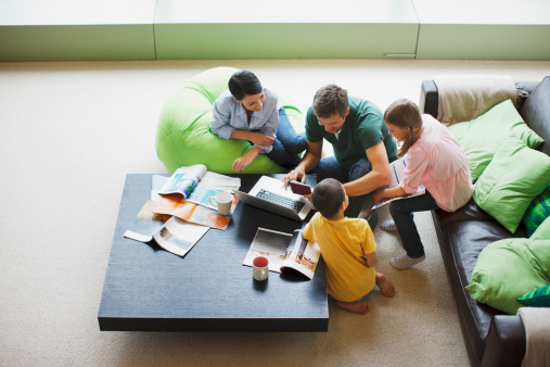 Family using laptop together in living room