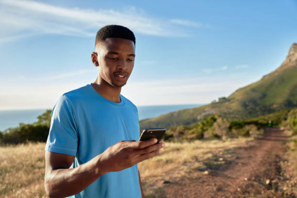 istock Black young Adult male setting his timer on his phone before going on his ountain trail run 1370879077