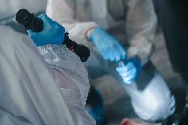 istock Criminologists in protective suits at the crime scene 1370879378